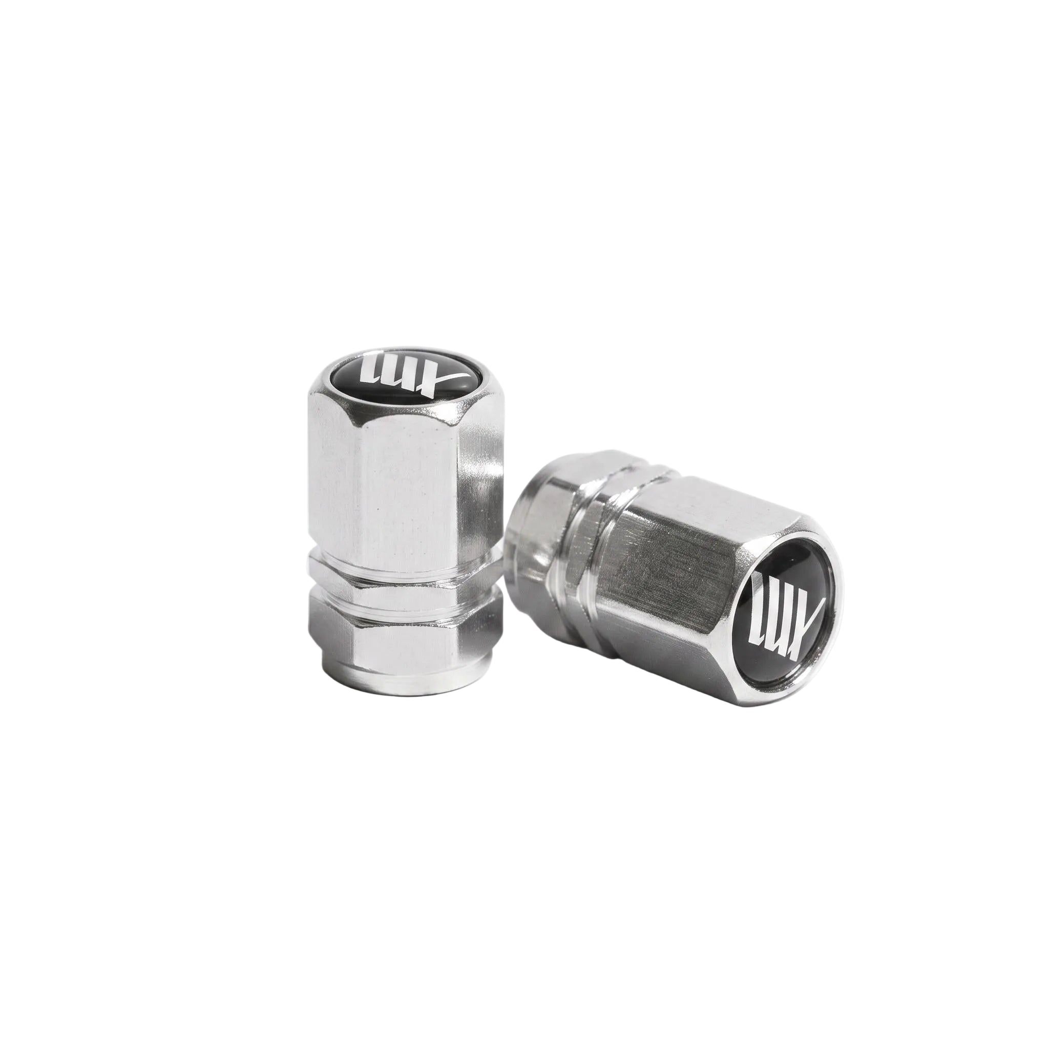 The LUXBMX Hex Logo Alloy Valve Cap (Pair) features two silver hexagonal alloy caps with a black and white "LUX" logo, perfect as stylish bike accessories, shown on a white background.