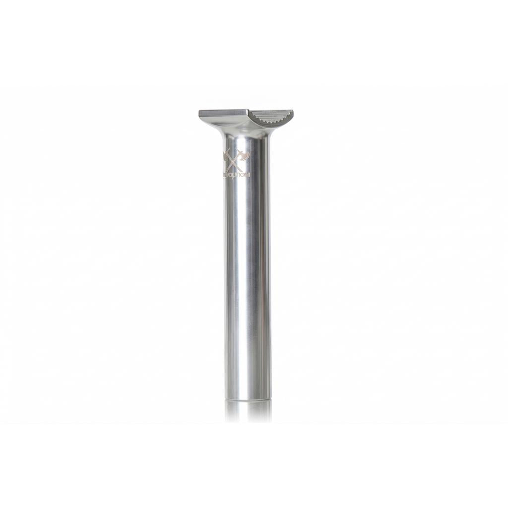 The Demolition Axes Pivotal Seat Post is a low-profile, silver metal bicycle seatpost made from forged alloy for durability, shown standing upright on a white background.