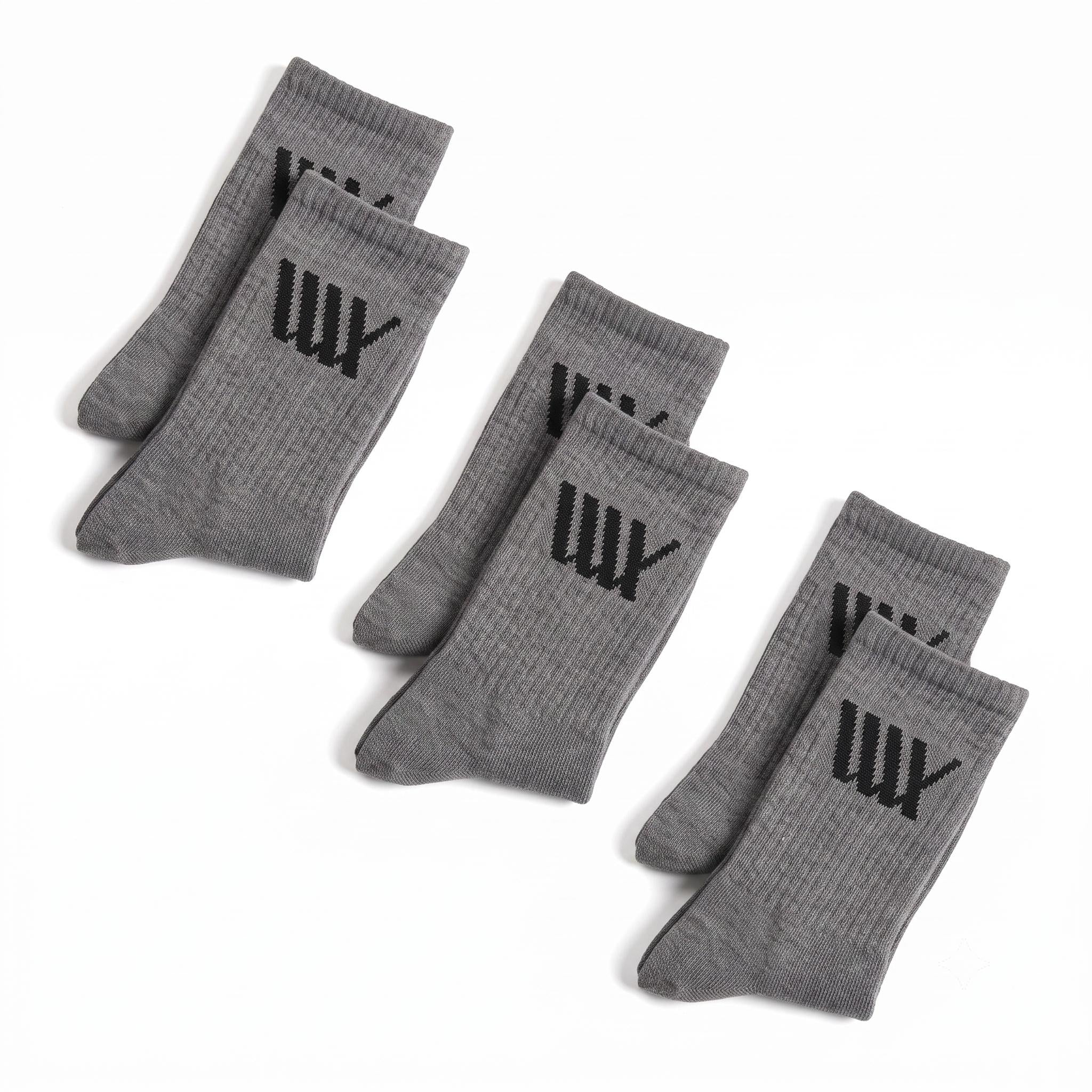 Six pairs of gray LUXBMX Crew Socks (two 3 packs), each featuring a black "W" design, are displayed on a white background. These premium crew socks are crafted from a soft bamboo blend for superior comfort and durability.