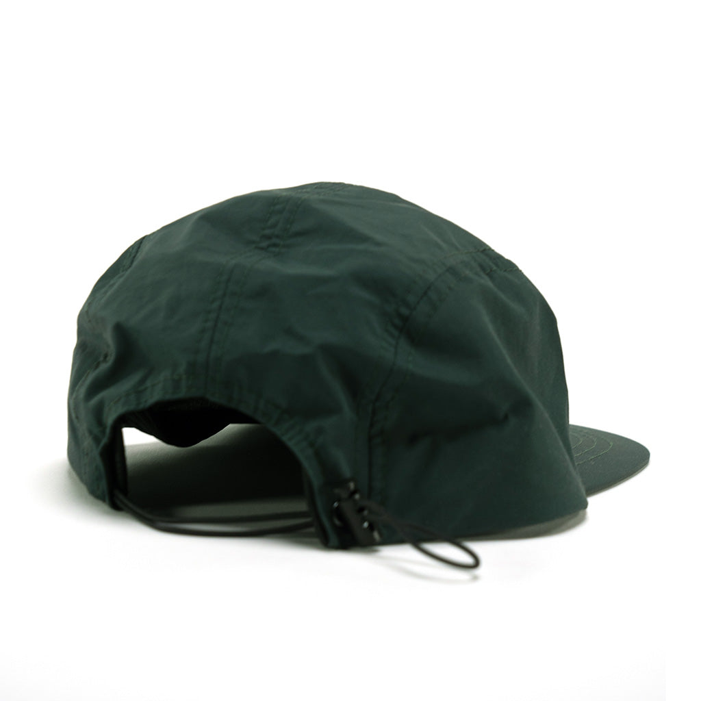 A LUXBMX Aero 5 Panel Cap - Dark Green made of polyester, featuring a green color and a zipper on the back.