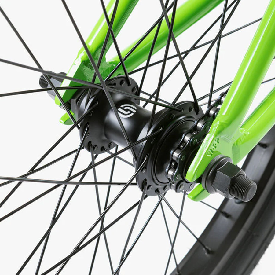 A close up of a green Wethepeople Nova 20 Inch BMX Bike wheel with black spokes.