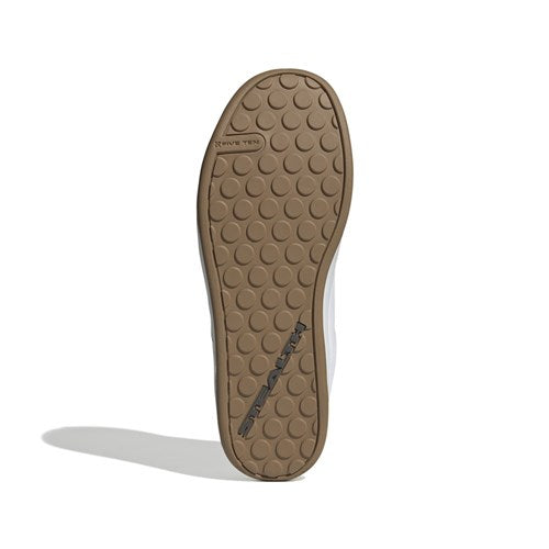 A brown rubber sole with a circular grip and the "SPEZIAL" logo, engineered for pedal-grip control like that of the Five Ten Freerider Pro Flat Core Shoes in White/Core Black/Red.