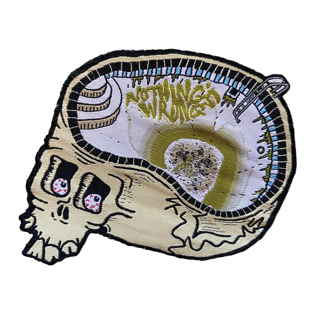 The Nothings Wrong Drain Brain Patch features a skull with a swimming pool inside, "Nothing’s Wrong" graffiti on the wall, and a diving board—a unique iron-on patch for that Brain Drain vibe.