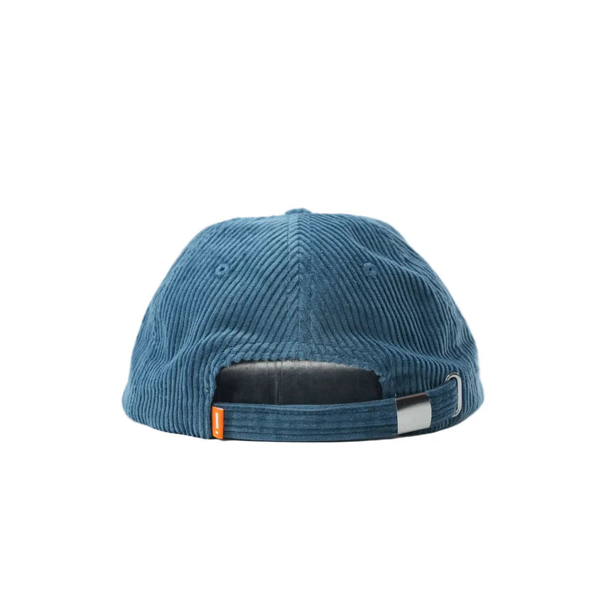Mahd Botanical Corduroy Hat in blue, shown from the back with an adjustable strap, metal buckle, and small orange tag—elevate your style with this premium cap inspired by Boyd Hilder.