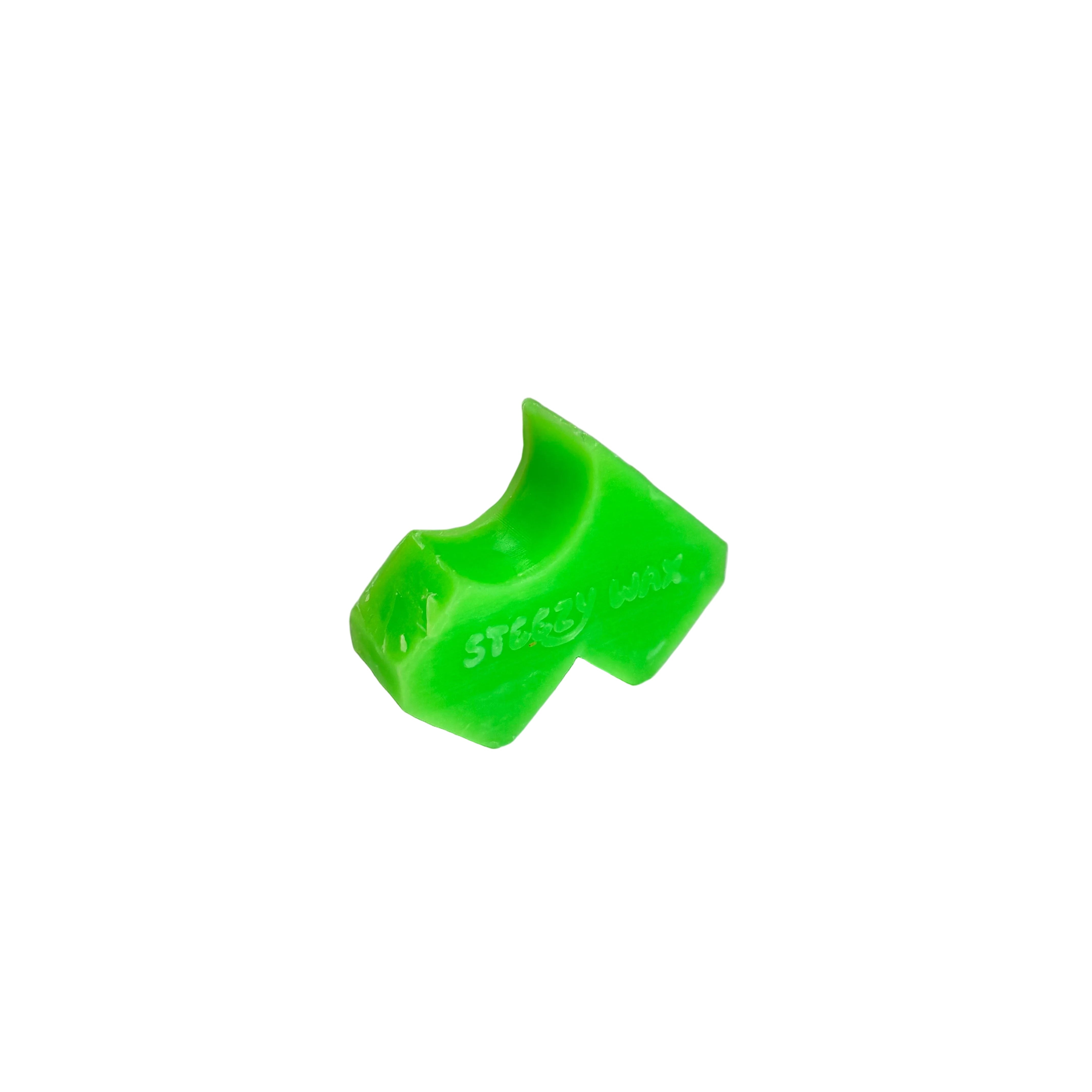 The Steezy Wax / Straya is a handmade bright green crayon skate wax with a bite taken out of one end, made in Australia and shown isolated on a white background.
