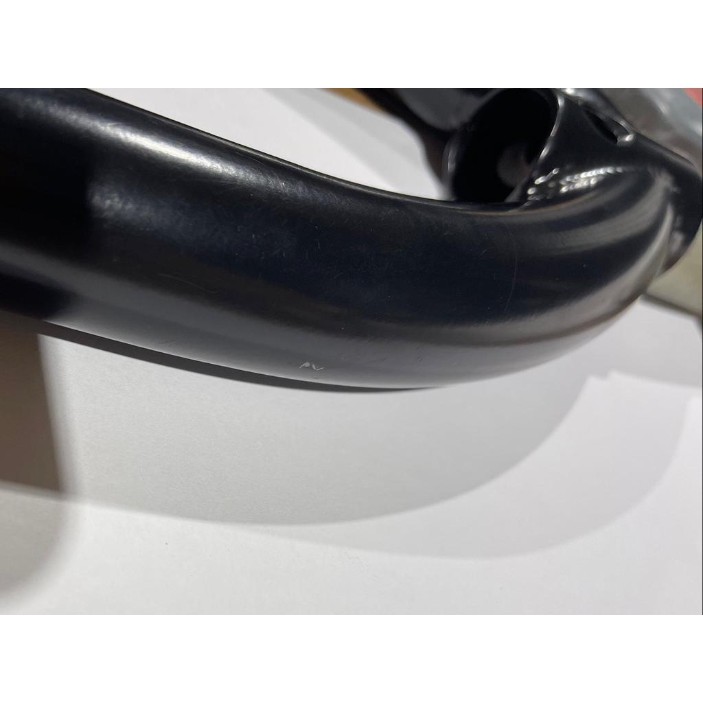 Close-up of S&M Pitchfork 20 Inch Forks (Scratch and Dent), black 4130 CrMo BMX fork resting on a white surface, with a small marking visible on the tube.