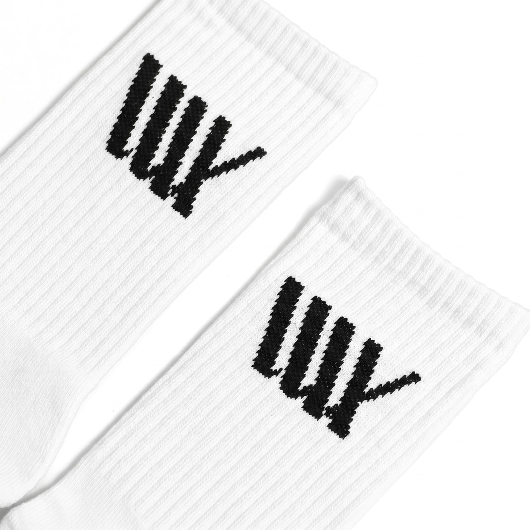 The LUXBMX Crew Socks are white, ribbed, and feature a black "UNDEFEATED" tally mark logo on each. Made from a durable bamboo blend, they offer lasting comfort and performance. Comes as a pack of two.