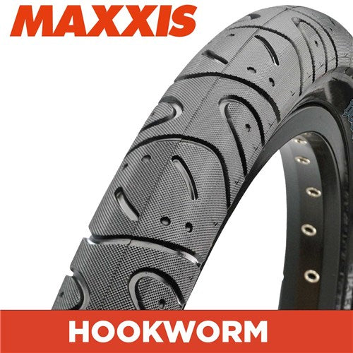 Close-up of the Maxxis Hookworm 26 Inch Tyre, featuring its rugged tread and bold red and white "MAXXIS" and "HOOKWORM" branding—ideal for BMX riders who need durable, grippy performance for urban riding.