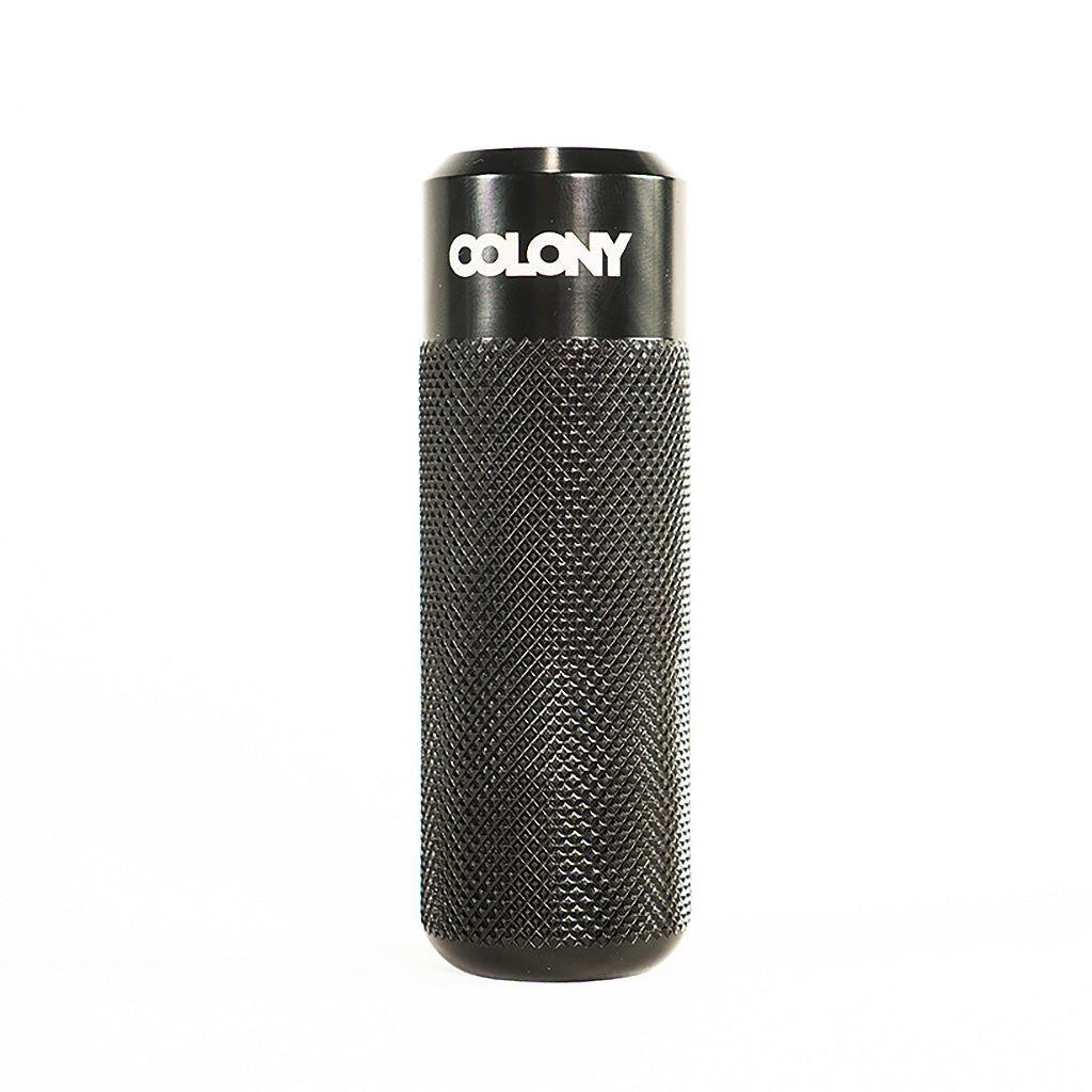 A high-quality black Colony Jam Circle Flatland Peg with the word Colony on it.