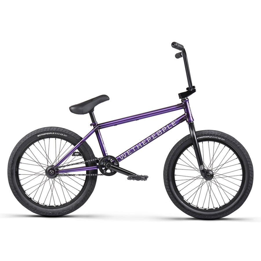 An Ultimate Performance BMX, the Wethepeople Trust 20 Inch Cassette Bike, with a purple color scheme stands out against a pristine white background.