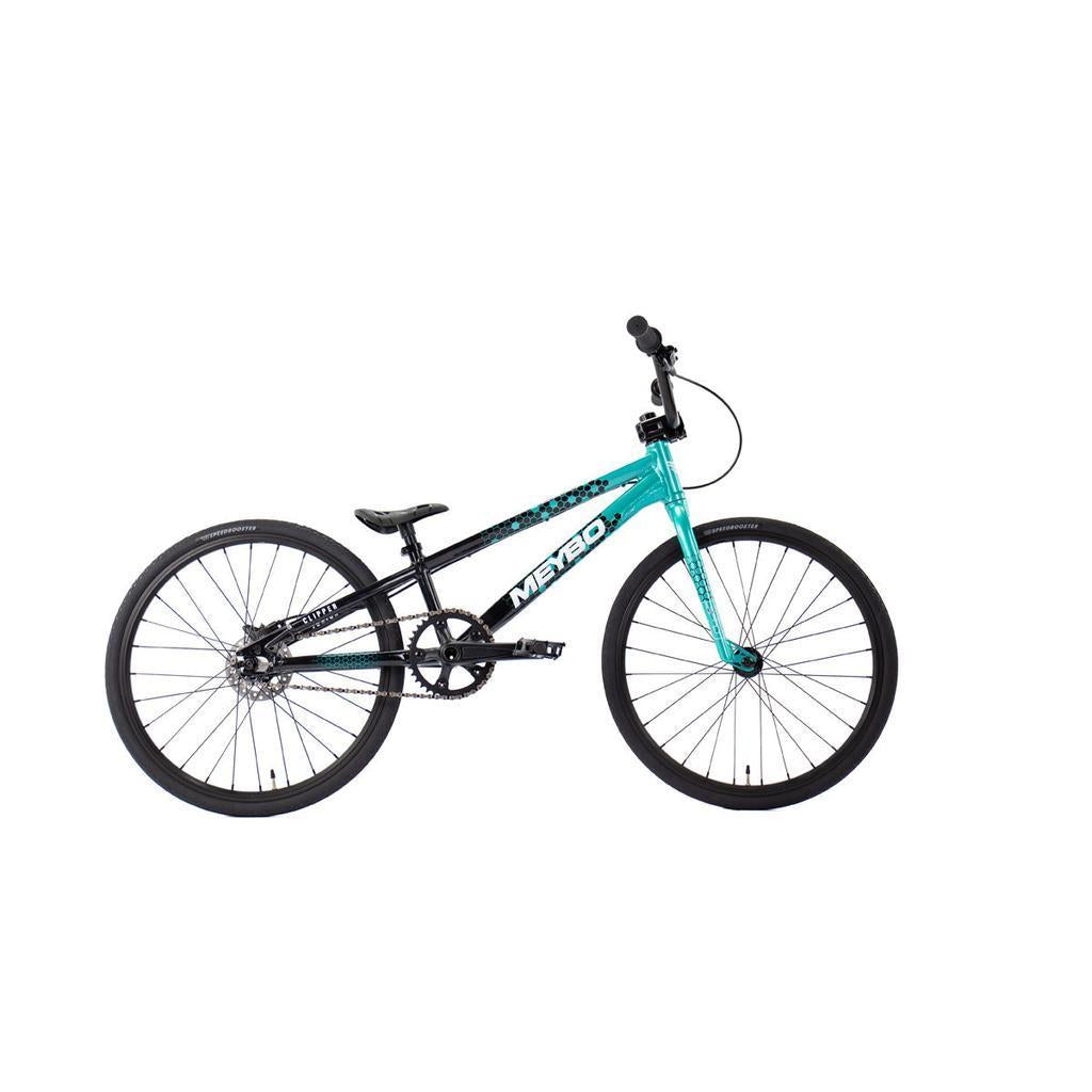 The Meybo 2026 Clipper Junior Bike is shown in profile on a white background, featuring thin tires, a small seat, and flat pedals—ideal as an entry-level BMX race bike.