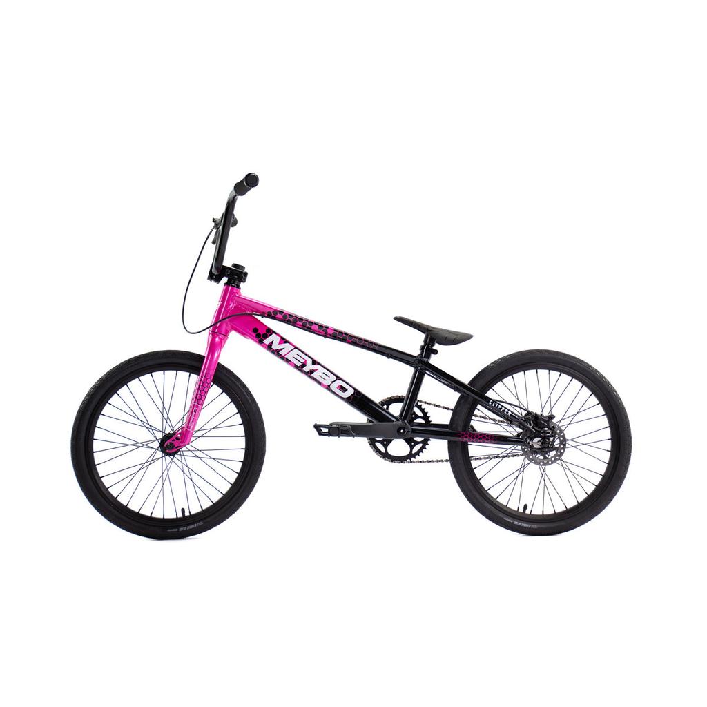 The Meybo 2026 Clipper Pro XL Bike is a BMX race bike with a pink and black frame, black seat, handlebar, and tires, displayed in side view against a white background.