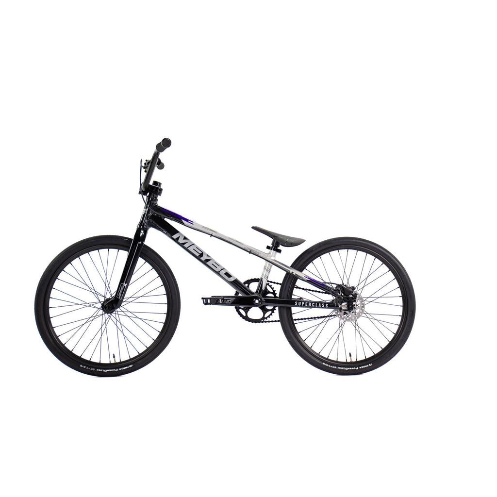 The Meybo 2026 Superclass Expert Bike is a black and white BMX racing bike with a tilted seat and flat handlebars, designed for tall riders and shown on a white background.