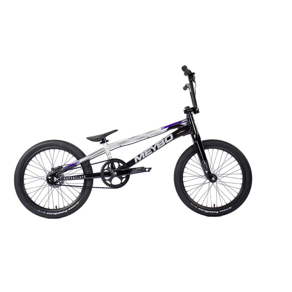 The Meybo 2026 Superclass Pro XXXL Bike is a black and silver BMX racer with a 22” top tube, ideal for tall riders. It includes two wheels, flat pedals, and straight handlebars, shown on a white background.