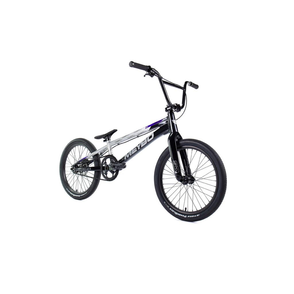 The Meybo 2026 Superclass Pro XXXL Bike, in black and silver, features a sturdy 22” top tube frame, thick tires, flat pedals, and a high handlebar—ideal for tall BMX riders—displayed against a white background.