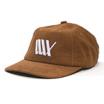 The LUXBMX Outfield Cap Brown is a brown corduroy baseball cap with a white embroidered tally mark logo on the front, shown angled against a white background.