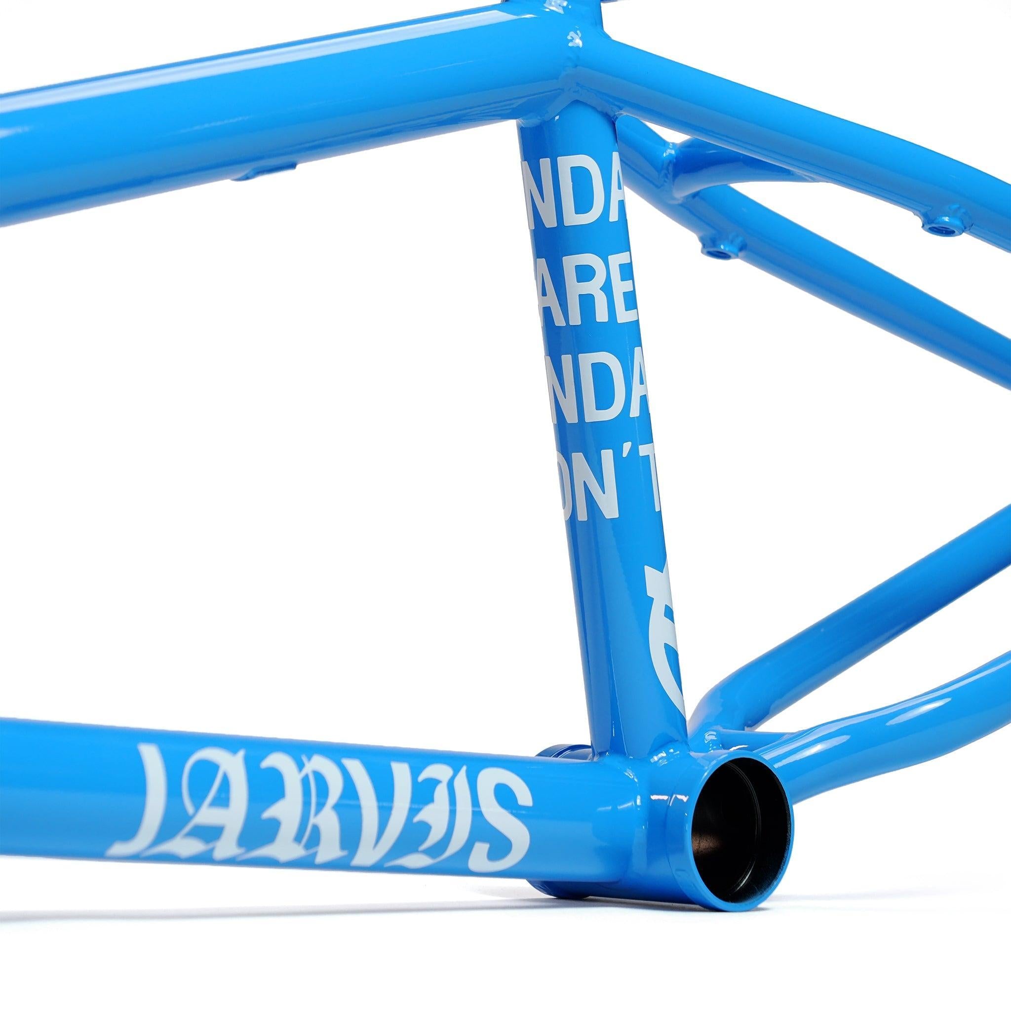 Close-up of the Federal Jarvis V2 Frame in blue, showing white branding decals on the bottom bracket area and removable brake mounts.