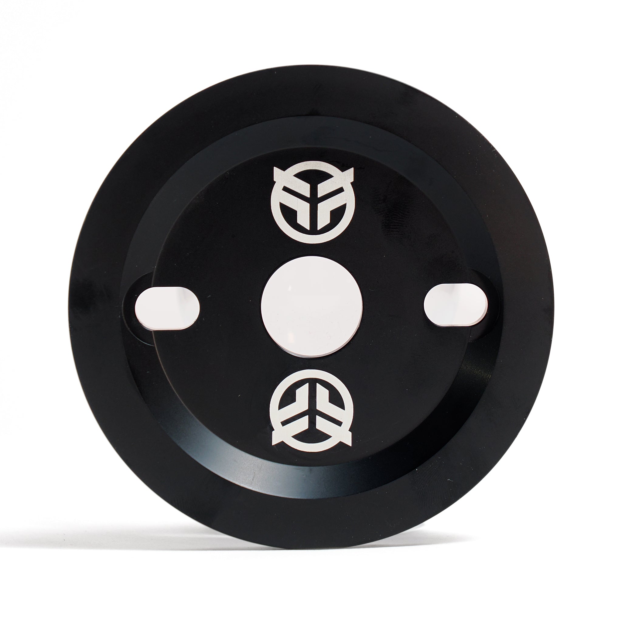 The Federal Code Guard Sprocket is a black circular metal sprocket with two oval slots, a central hole, and three white abstract Federal logos—designed for BMX enthusiasts.