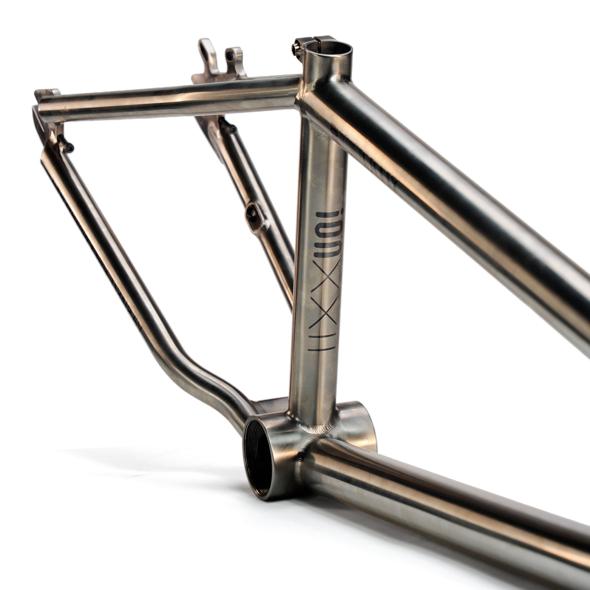 A close-up of the ION BMX Ti22 Titanium 22 Inch Frame showcases welded joints, a brushed finish, and the Ti22 logo on the seat tube. The sleek tubing subtly displays the precise 74-degree headtube angle in its design.