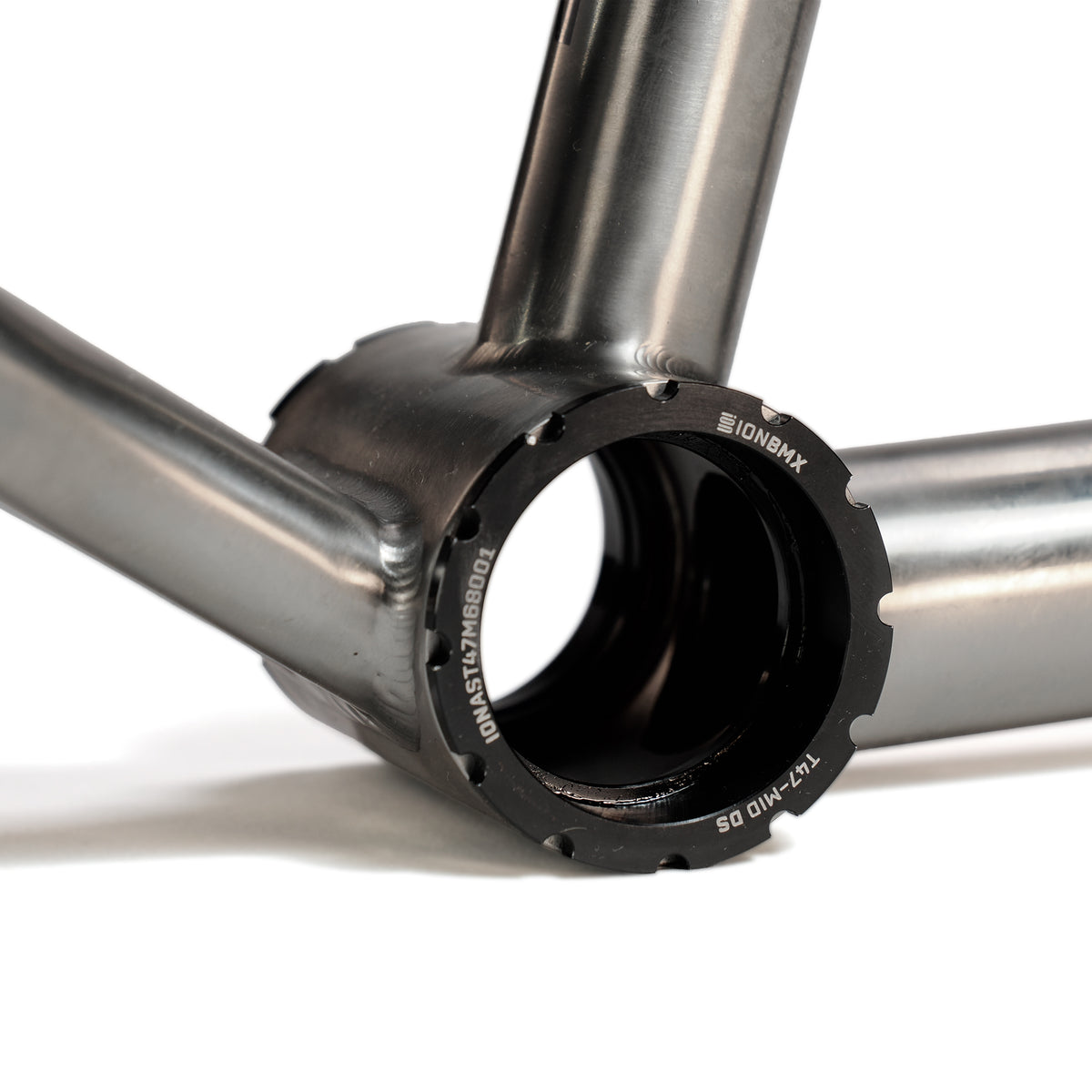 Close-up of the ION BMX Ti22 Titanium 22 Inch Frame’s metallic bottom bracket shell, showcasing visible threads and smooth welds for precise fit and enhanced durability.