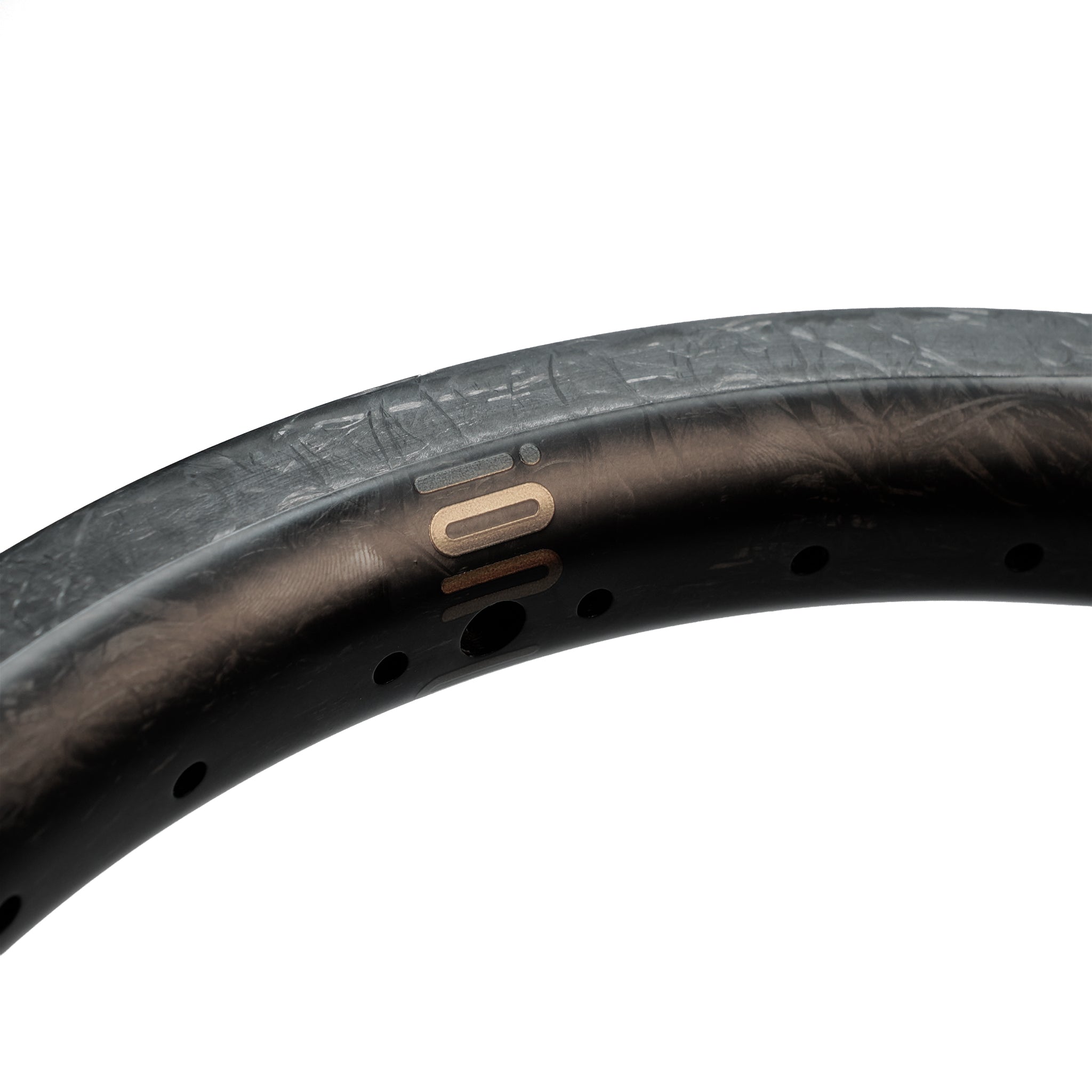 Close-up of the ION BMX C18 Carbon Fiber 18 Inch Braking Rim featuring a matte black finish, small ventilation holes, and a subtle metallic logo.
