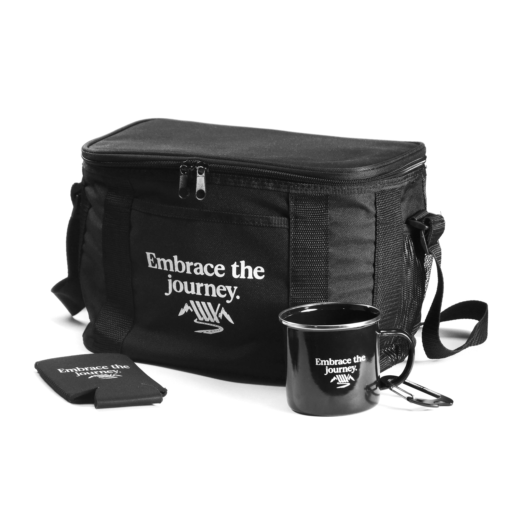 The LUXBMX Journey Adventurer Bundle features a black insulated cooler bag, ceramic mug, and can holder—all with “Embrace the journey.” in white—displayed on a white background, perfect for any adventurer.