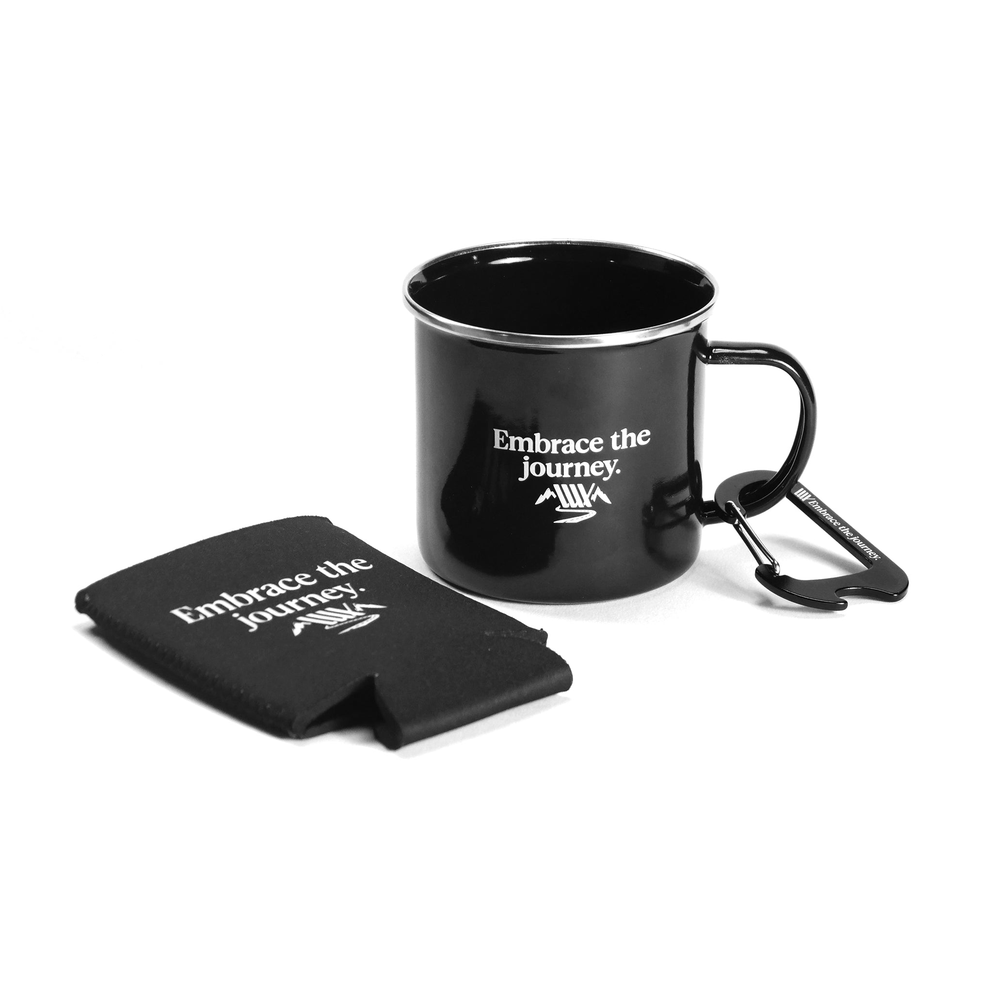 The LUXBMX Journey Explorer Bundle includes a Black Enamel Mug with a carabiner handle and matching black stubby cooler, both featuring “Embrace the journey.” in white text—perfect for any adventure.
