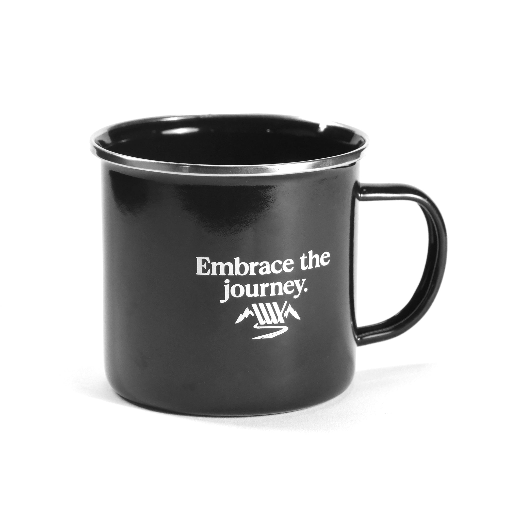 The LUXBMX Journey Adventurer Bundle includes a black enamel mug with a handle, featuring "Embrace the journey." in white text and a small mountain graphic—ideal for every adventure lover.