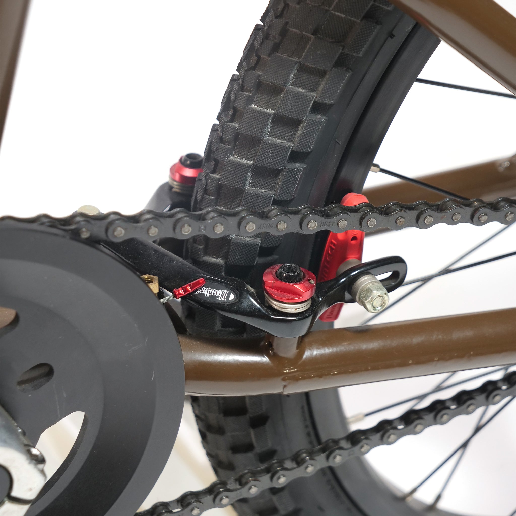 Close-up of the Terrible One Barcode Garrett Byrnes Custom 20 Inch Bike (2003) rear wheel, showcasing the chain, tire, and signature chain tensioner—an iconic Mid School frame detail—set against a white background.
