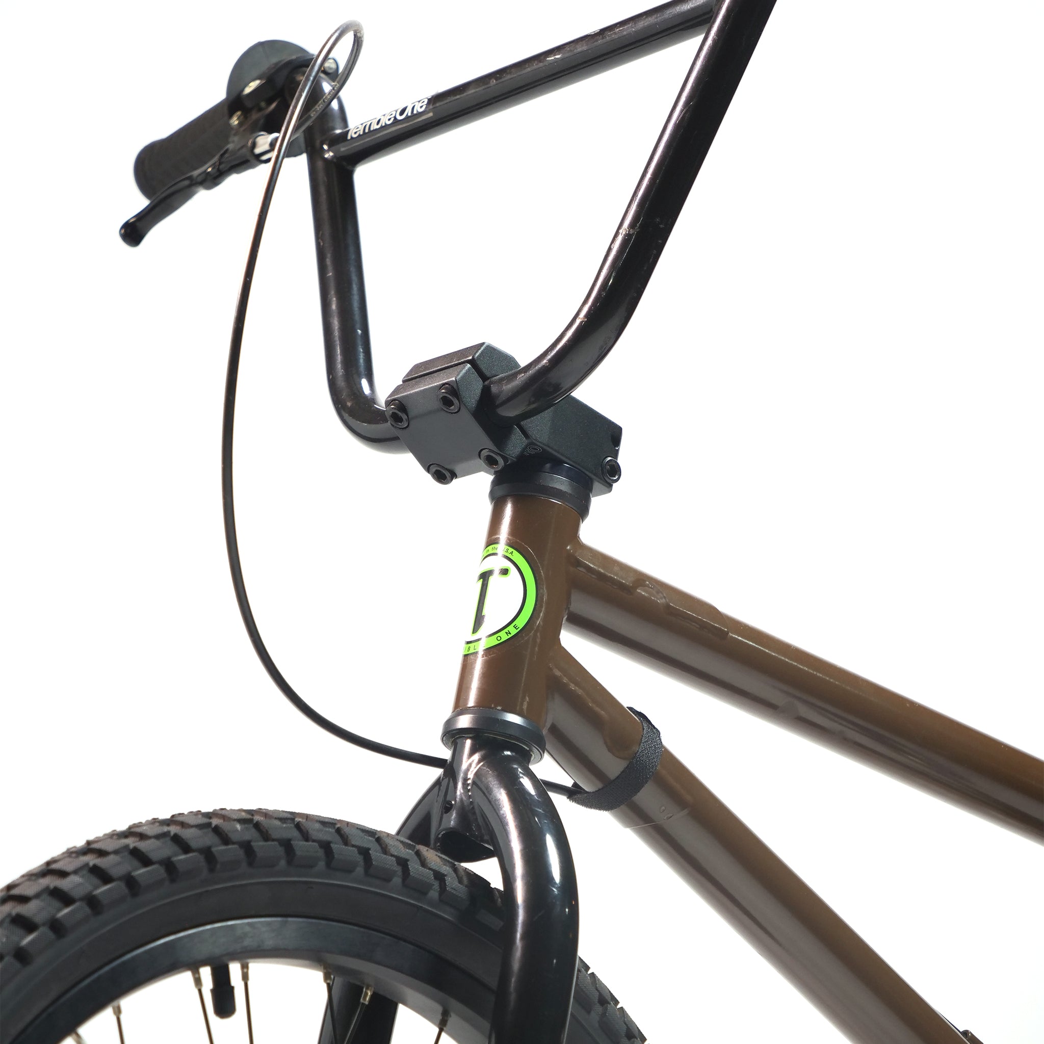 Close-up of a Terrible One Barcode Garrett Byrnes Custom 20 Inch Bike (2003) BMX in brown, highlighting Mid School frame, handlebars, front tire, and brake cable against a white background.