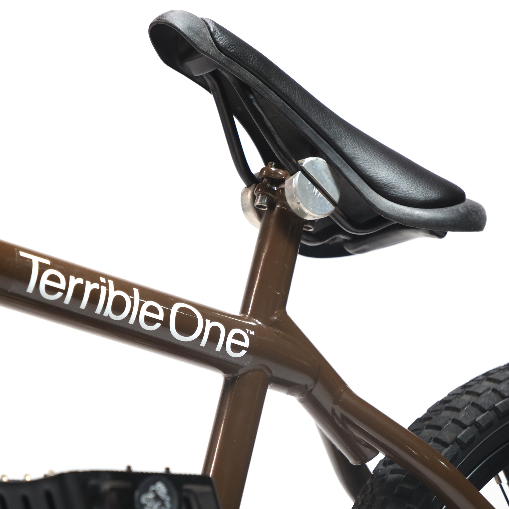 Close-up of a brown Terrible One Barcode Garrett Byrnes Custom 20 Inch Bike (2003), a classic Mid School frame, showing the brand name and black seat against a white background.