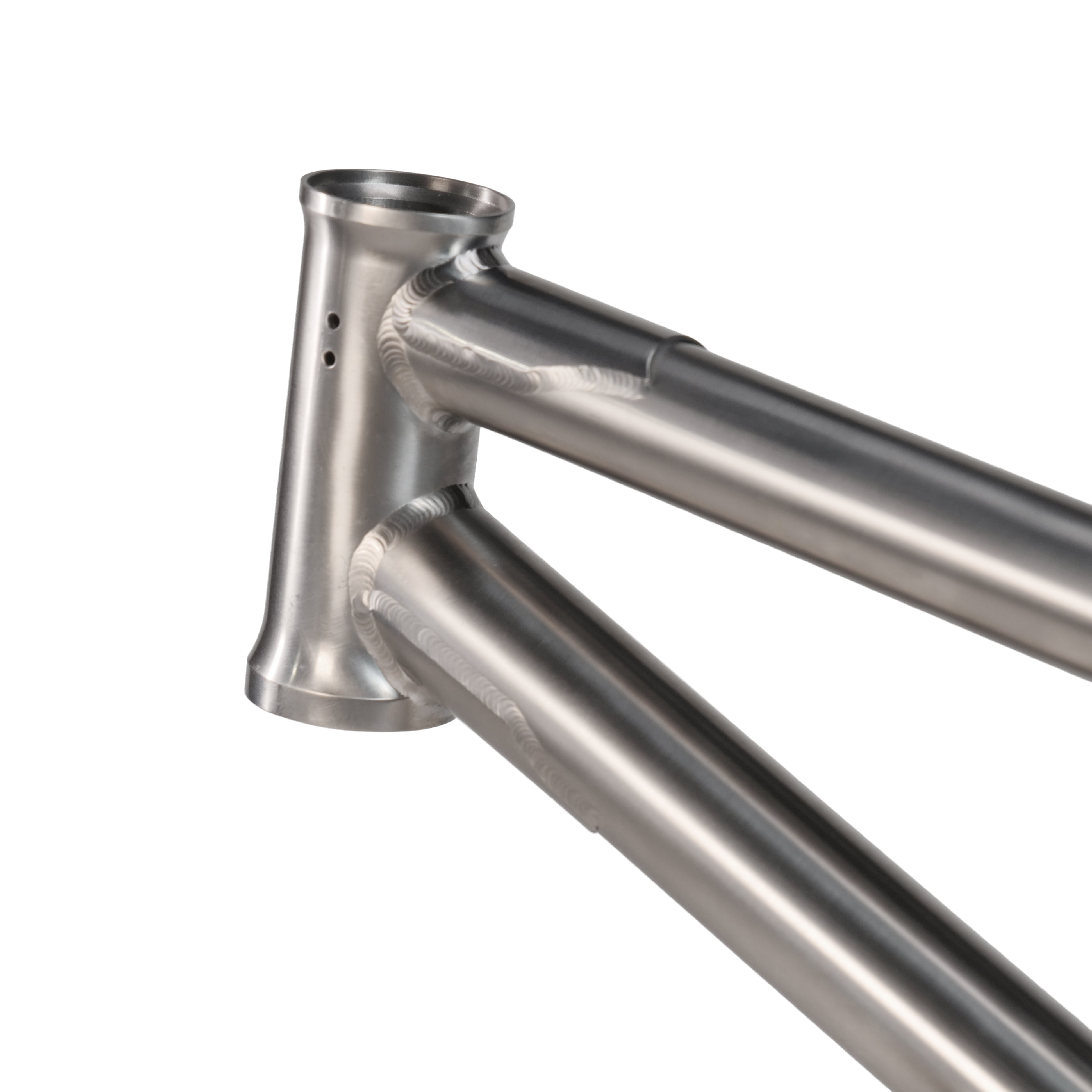 Close-up of the ION BMX Ti18 Titanium 18 Inch Frame, highlighting the head tube and two welded tubes with a brushed titanium finish and visible machining marks.