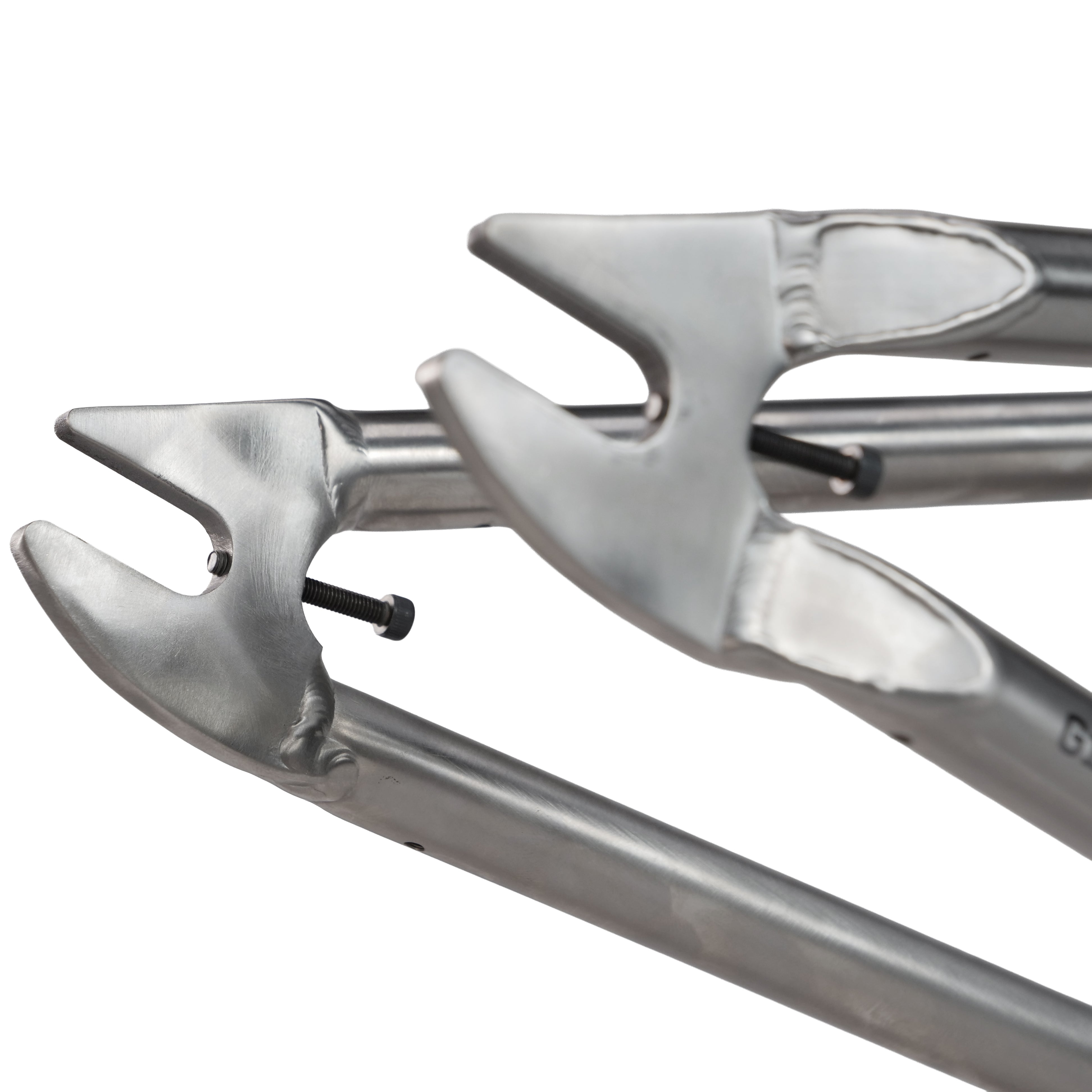 Close-up of two metallic open-ended wrench heads with a screw between them—perfect tools for assembling or adjusting the ION BMX Ti16 Titanium 16 Inch Frame.