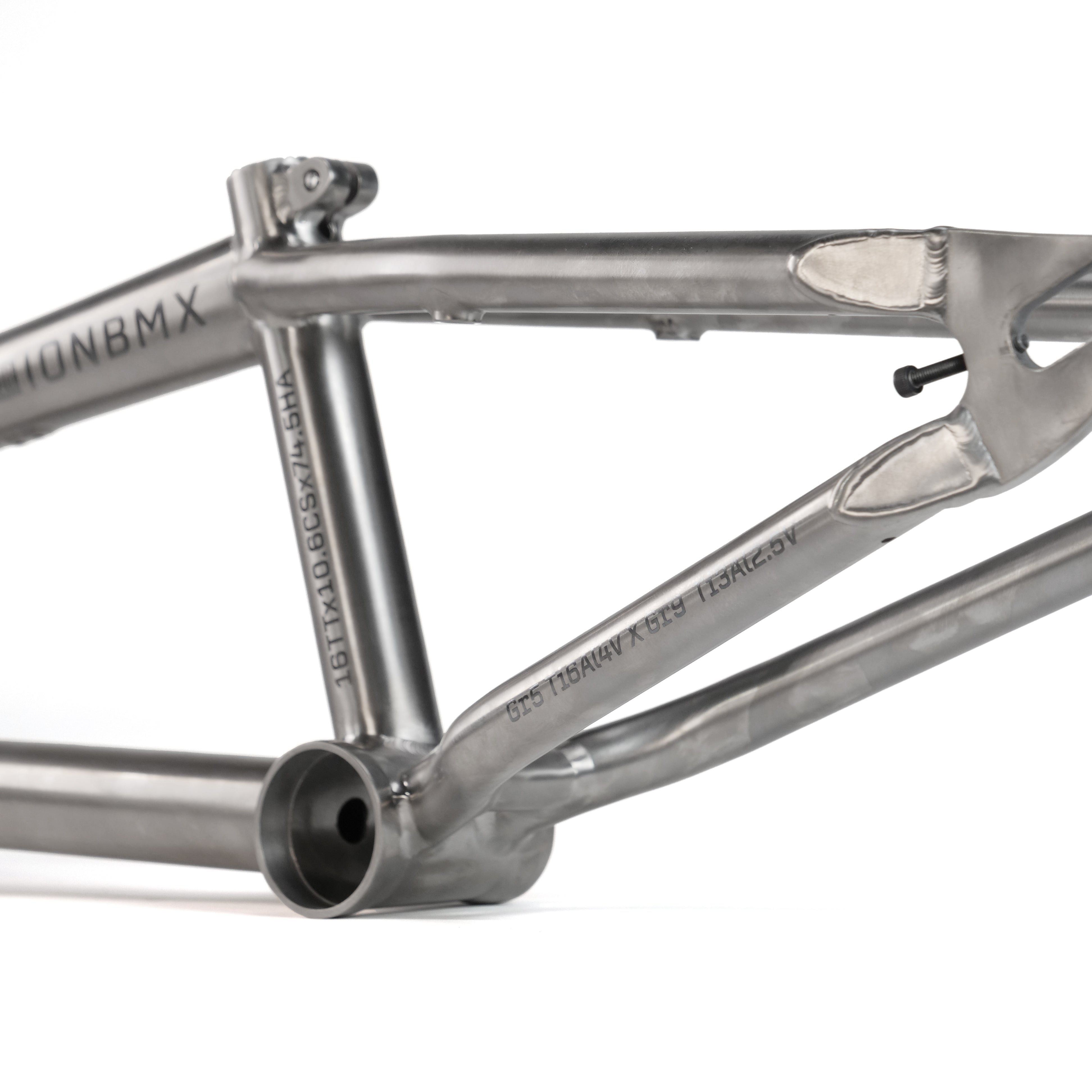 A close-up of the ION BMX Ti16 Titanium 16 Inch Frame shows precision welds, clean tubing junctions, and engraved branding on the lightweight titanium surface.