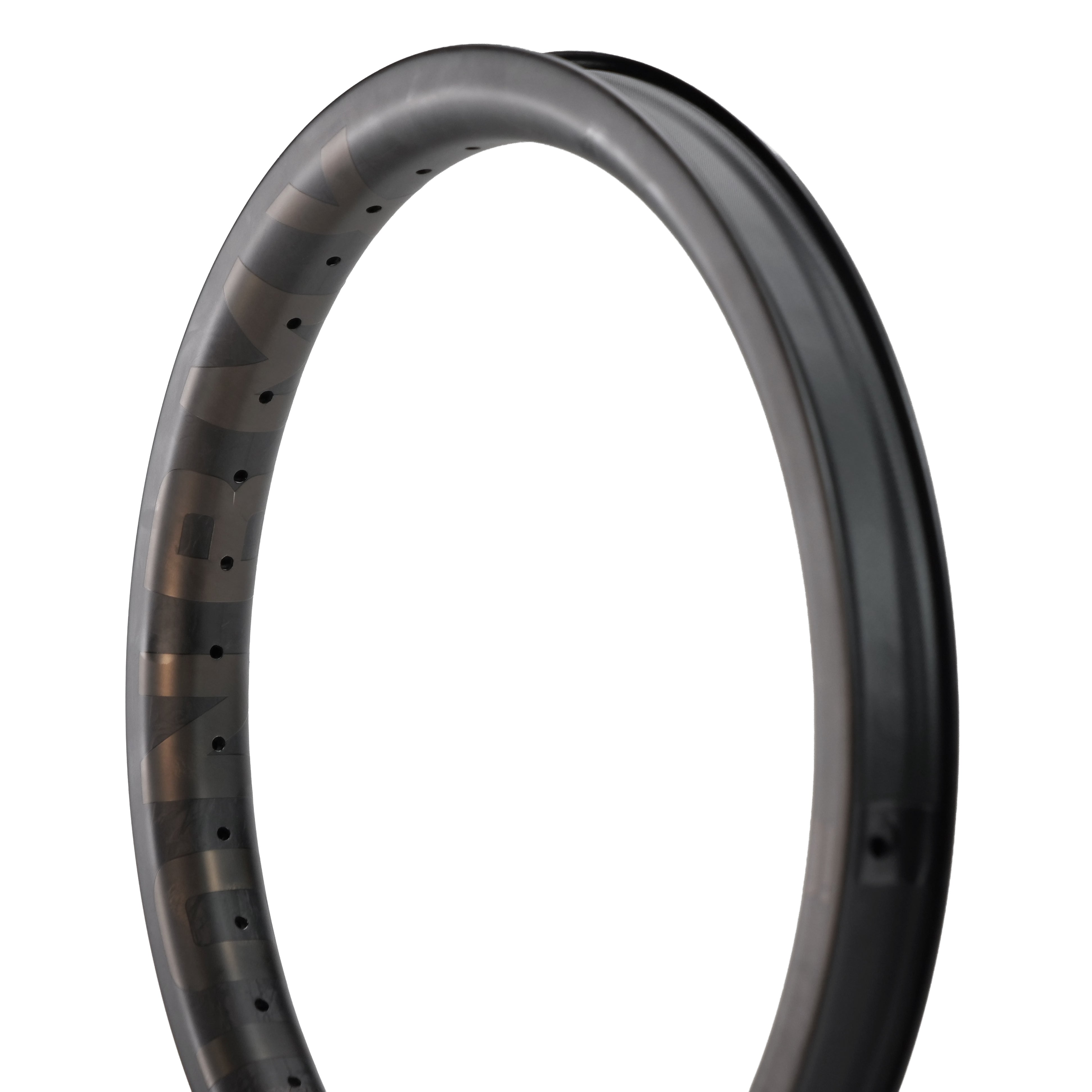 Close-up of an ION BMX C18 Carbon Fiber 18 Inch Brakeless Rim in black Toray T800s, showing spoke holes and matte finish, photographed against a white background.