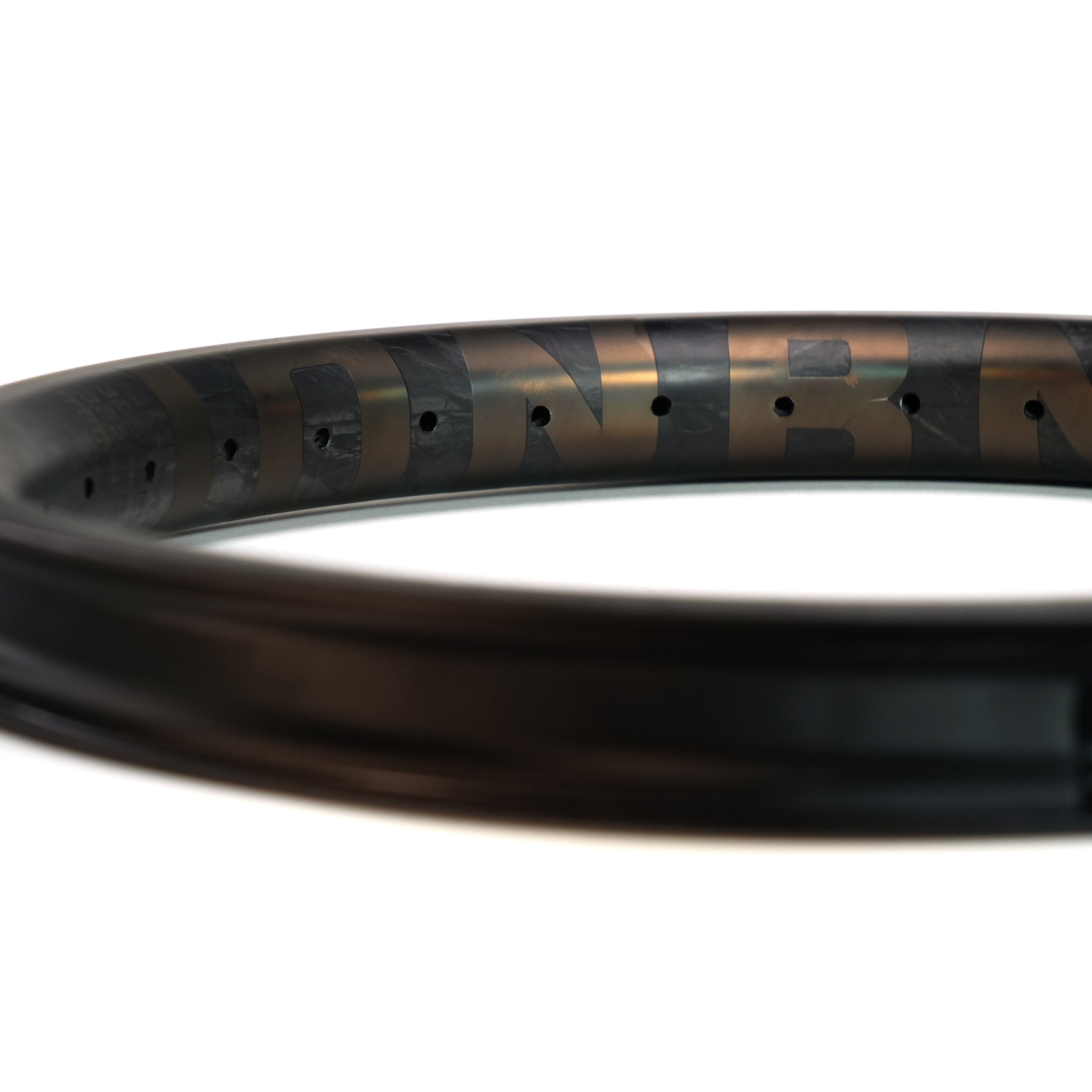 Close-up of the ION BMX C18 Carbon Fiber 18 Inch Brakeless Rim, featuring spoke holes and subtle branding, highlighting the strong, durable construction ideal for freestyle BMX use.