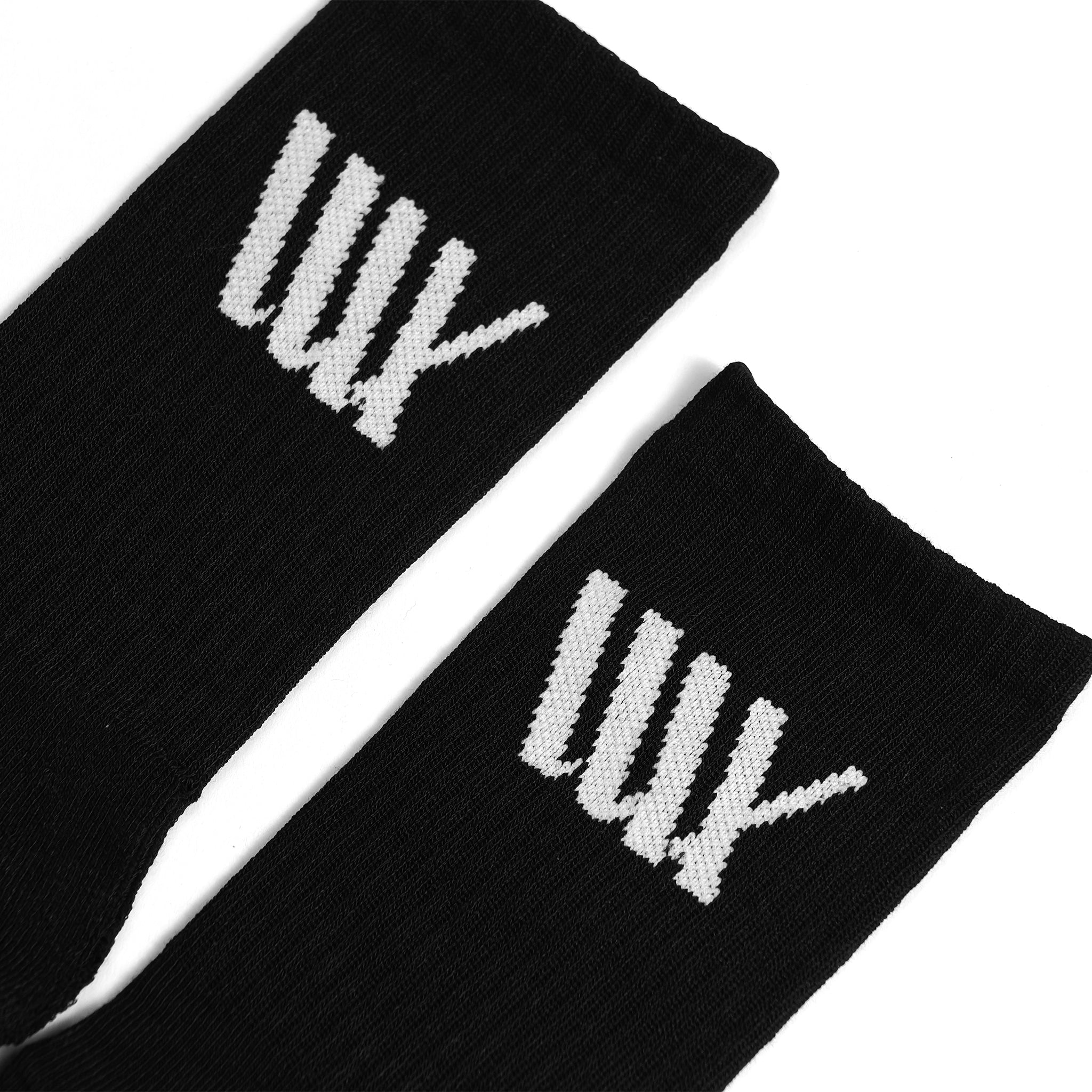 The LUXBMX Crew Socks are black cotton-blend socks with a white stylized "w" near the top—ideal for BMX enthusiasts who want comfort and style.