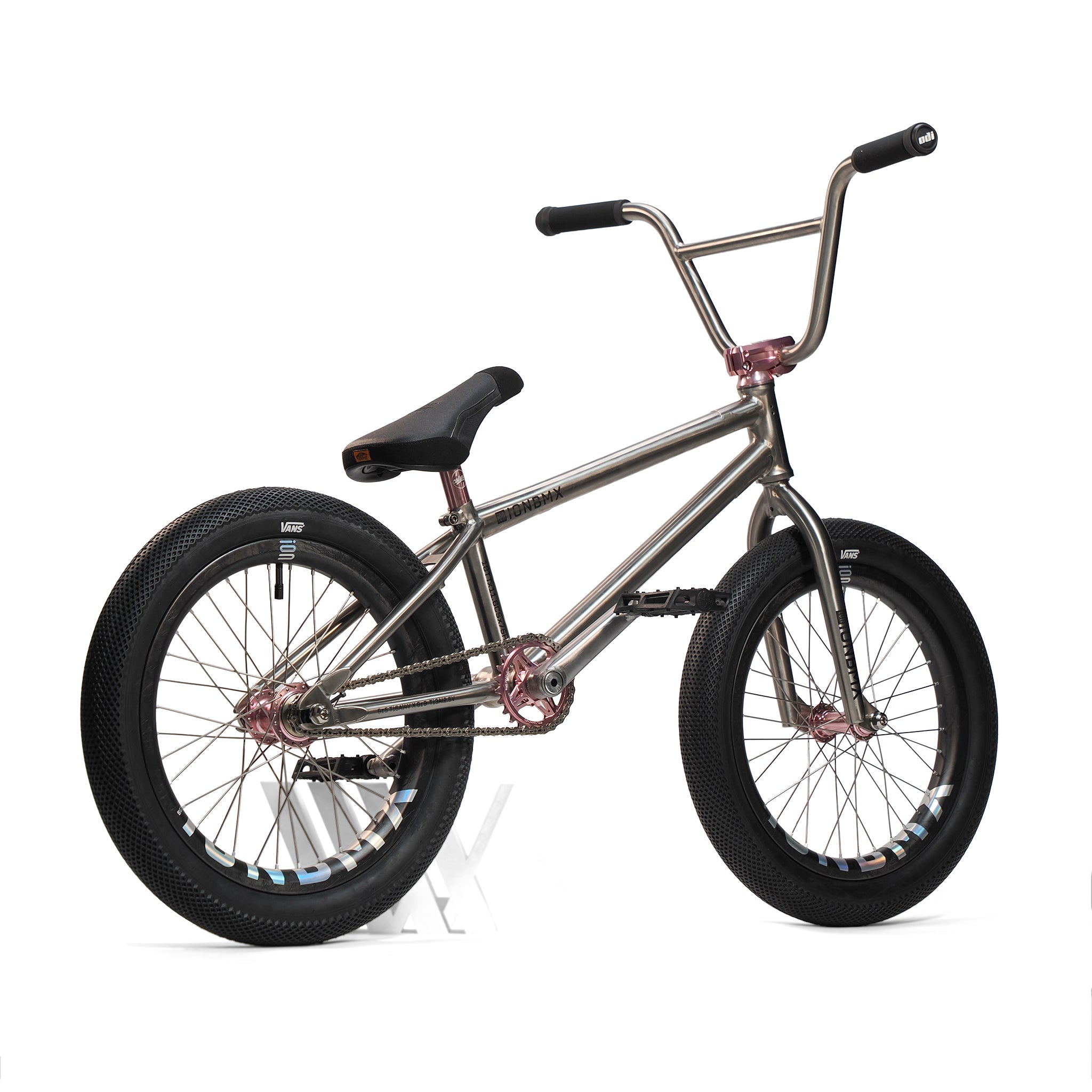 An ION BMX Ti18 Custom Titanium 18 Inch Bike is shown on a white background, featuring a metallic titanium frame, black seat, and black tires. This lightweight freestyle BMX bike offers superior performance and durability.