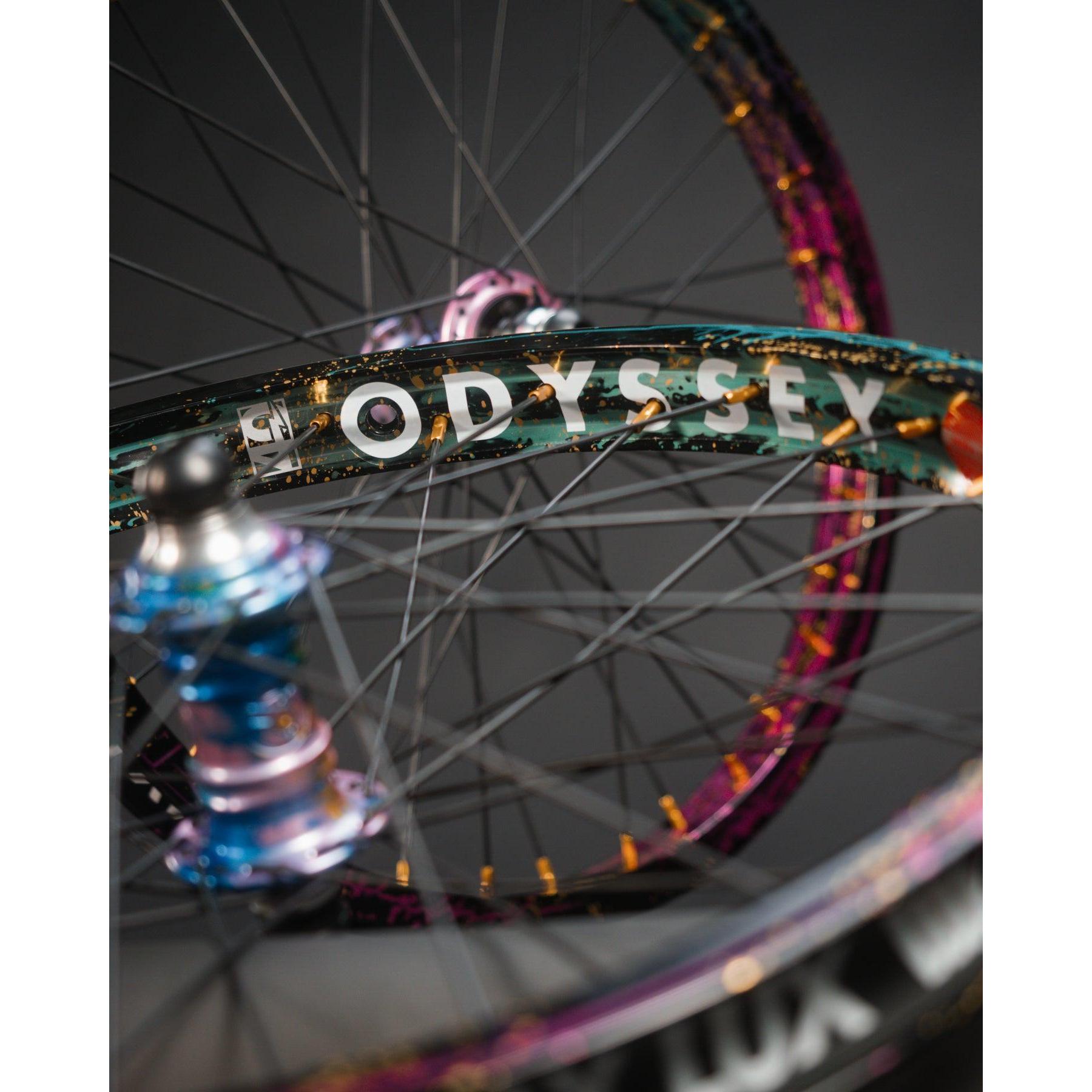 Close-up of two bicycle wheels with colorful rims; the limited edition Profile x Odyssey Near Earth Objects Wheel Set is prominently displayed, highlighting this BMX hub and Right Hand Drive setup.