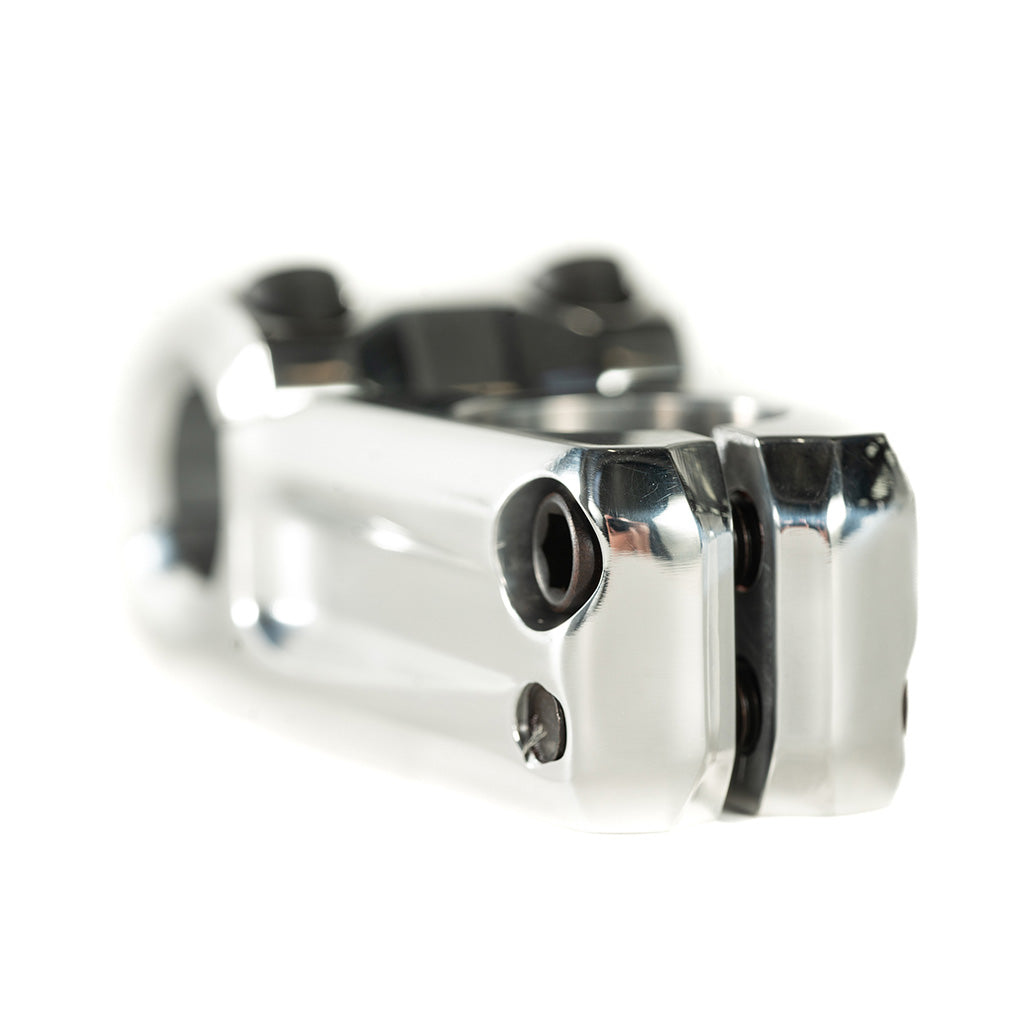 A close up of a Colony Variant 52mm BMX Stem, a chrome handlebar clamp on a white background.