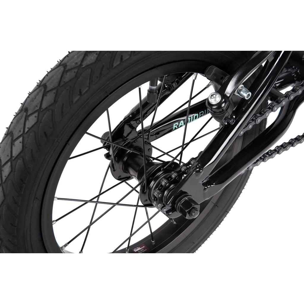 Close-up of the rear wheel and hub on the Radio Revo 14 Inch bike, highlighting the tire, spokes, chain, and frame—ideal details for anyone selecting their first BMX.