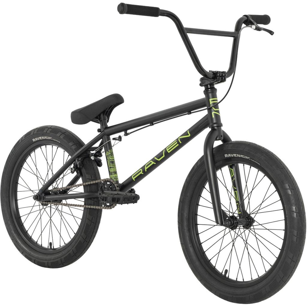 The Raven LC 20 Inch Bike is a black BMX with thick tires and "RAVEN" in green on its chromoly frame, displayed front-side on a white background.