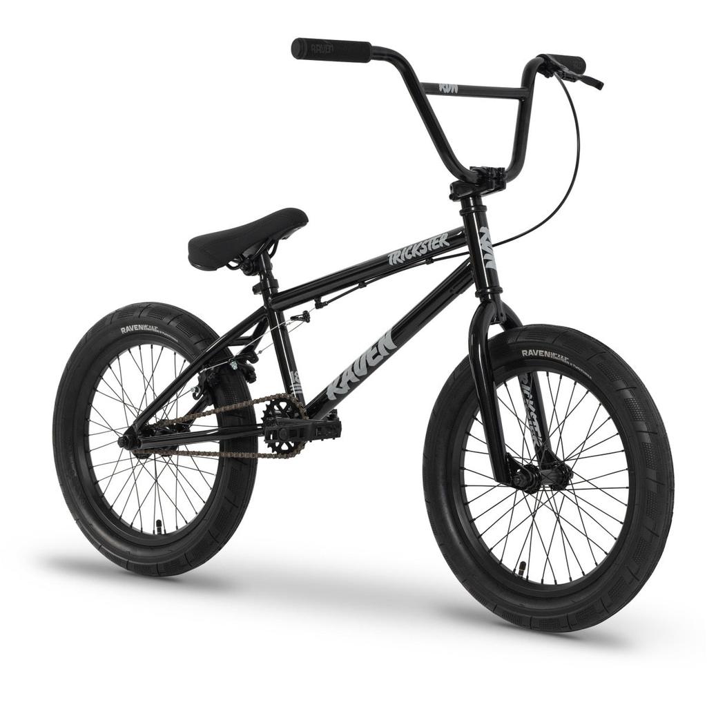 The Raven Trickster 18 Inch Bike, shown against a white background, features a black frame with thick tires, sealed bearing hubs, chromoly cranks, single gear, straight handlebars, and “Raven” and “Trickster” labels.