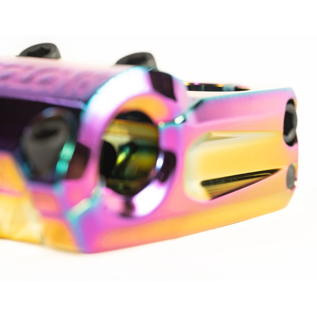 A close up of a Colony Variant 52mm BMX Stem, with rainbow-colored design.