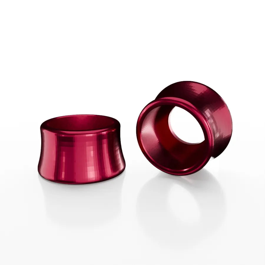 Two shiny SD-X Sniper Evo 10mm Bolt Caps in metallic red aluminum, crafted from high-performance 7075 alloy, are displayed on a white background—one upright and one lying down.