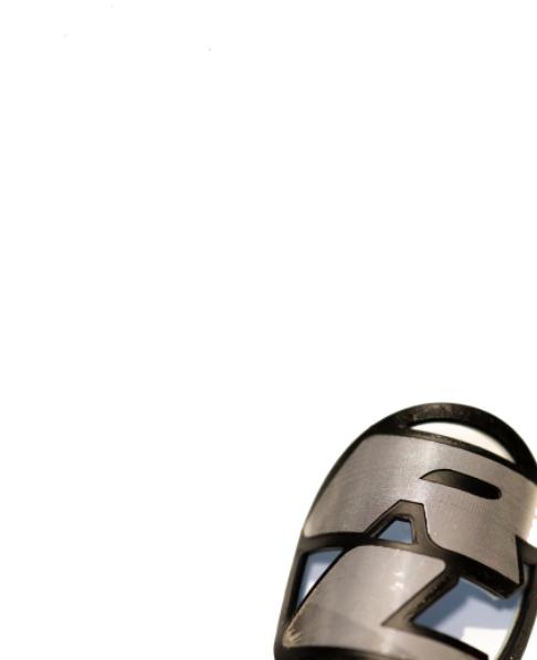 Close-up of a Redline Headtube Badge, featuring geometric metallic cutouts and vintage detailing, set against a white background in the lower right corner.