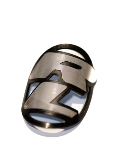 The Redline Headtube Badge is a metallic emblem with a stylized "RZ" on white, ideal for retro rebuilders searching for authentic or new old stock Redline head badges.