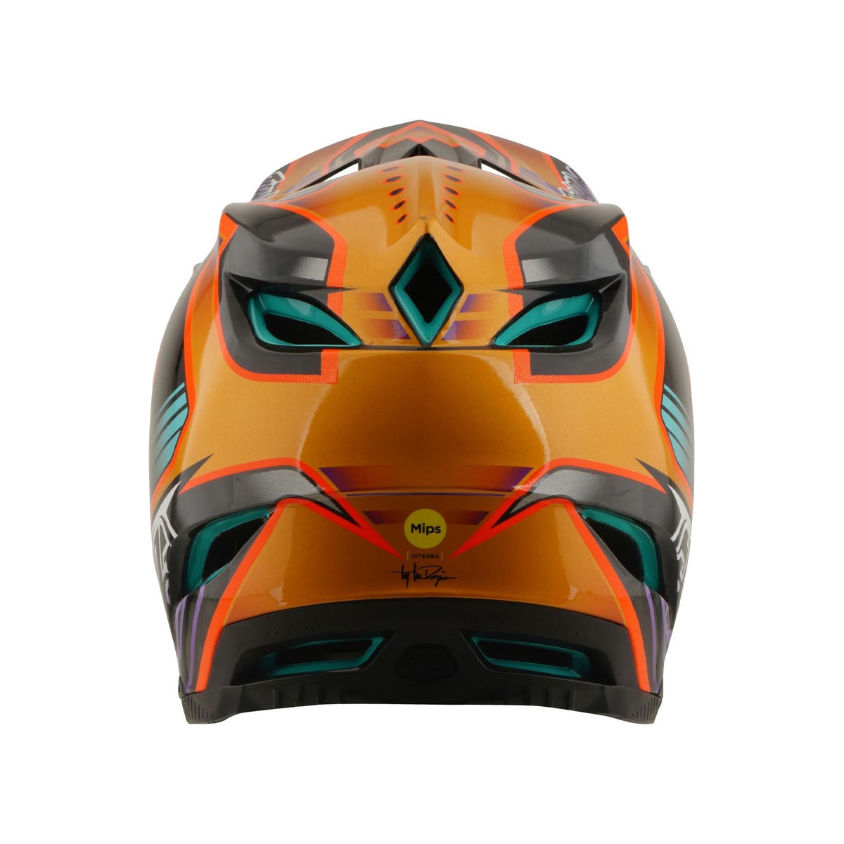 The TLD 26.1 D4 AS Carbon Helmet in Crest Gold features bold orange and black geometric designs with teal and red accents, a full-face build, and a visible "Mips" safety sticker on the back.