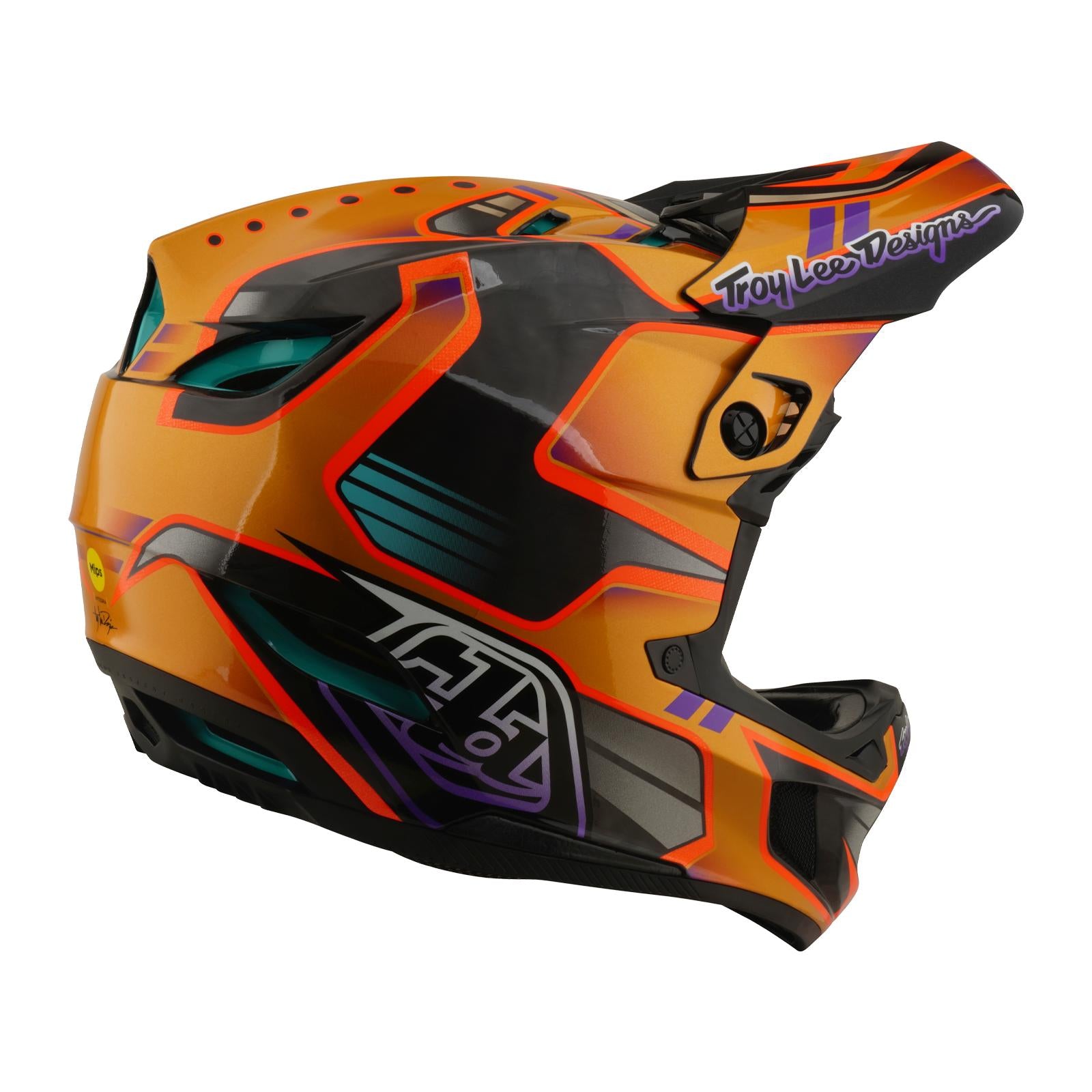 The TLD 26.1 D4 AS Carbon Helmet / Crest Gold is a full-face motocross helmet with a Crest Gold geometric design, Troy Lee Designs logo on the side, and advanced Mips protection for enhanced safety.
