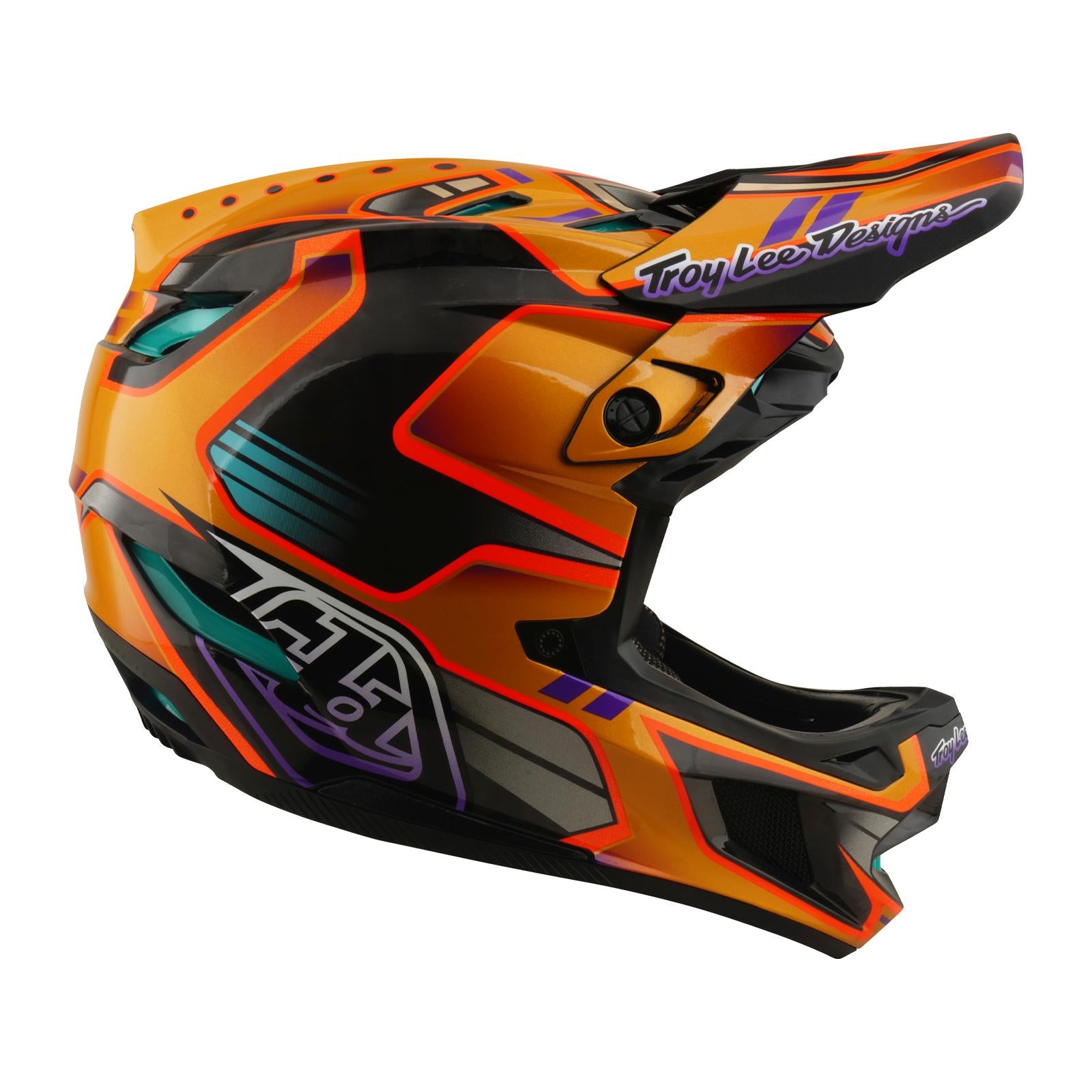 A side view of the TLD 26.1 D4 AS Carbon Helmet / Crest Gold, a brightly colored full-face mountain biking helmet with orange, black, purple, and teal accents, "Troy Lee Designs" visor logo, and advanced Mips safety protection.